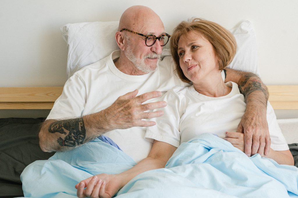 Older couple sitting in bed and talking